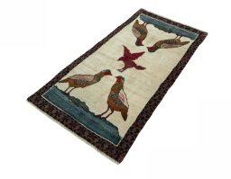 Corner detail of 2000s Persian Gabbeh rug showing border pattern and Wool pile