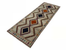 Corner detail of 2000s Persian Gabbeh rug showing border pattern and Wool pile