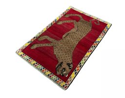 Corner detail of 2000s Persian Gabbeh rug showing border pattern and Wool pile