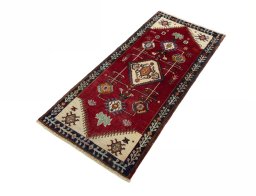 Corner detail of 2000s Persian Gabbeh rug showing border pattern and Wool pile
