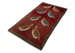 Corner detail of 2000s Persian Gabbeh rug showing border pattern and Wool pile