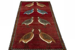 Surface texture of 2000s Persian Gabbeh rug with natural Wool and intricate pattern