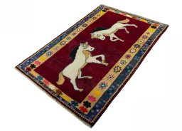 Corner detail of 2000s Persian Gabbeh rug showing border pattern and Wool pile
