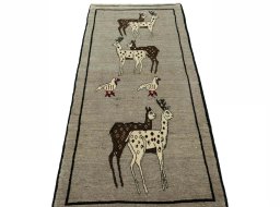 Surface texture of 2000s Persian Gabbeh rug with natural Wool and intricate pattern