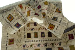 Corner detail of 2000s Persian Gabbeh rug showing border pattern and Wool pile