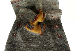 Corner detail of 2000s Persian Gabbeh rug showing border pattern and Wool pile