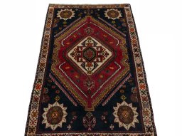 Surface texture of 2000s Persian Gabbeh rug with natural Wool and intricate pattern