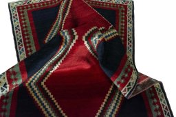 Corner detail of 2000s Persian Gabbeh rug showing border pattern and Wool pile