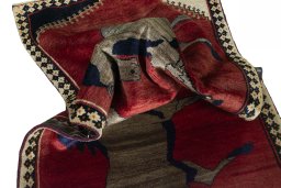 Corner detail of 2000s Persian Gabbeh rug showing border pattern and Wool pile