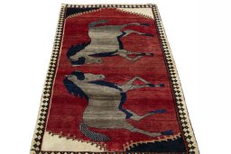 Surface texture of 2000s Persian Gabbeh rug with natural Wool and intricate pattern