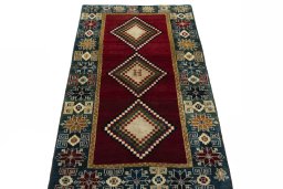 Surface texture of 2000s Persian Gabbeh rug with natural Wool and intricate pattern