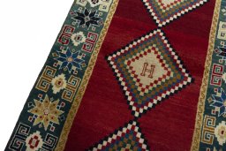 Backside of handmade 2000s Persian Gabbeh rug showing knot structure and weave density