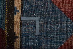 Corner detail of 2000s Persian Gabbeh rug showing border pattern and Wool pile