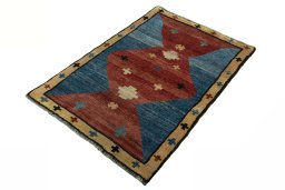 Corner detail of 2000s Persian Gabbeh rug showing border pattern and Wool pile