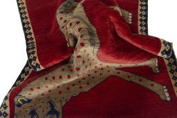 Corner detail of 2000s Persian Gabbeh rug showing border pattern and Wool pile