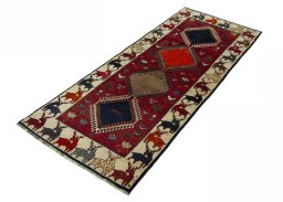 Corner detail of 2000s Persian Gabbeh rug showing border pattern and Wool pile