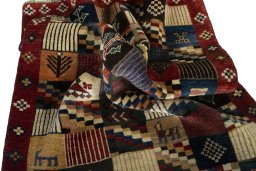 Corner detail of 2000s Persian Gabbeh rug showing border pattern and Wool pile