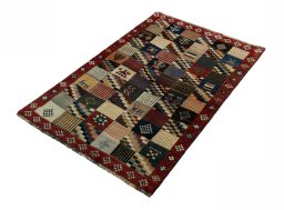 Corner detail of 2000s Persian Gabbeh rug showing border pattern and Wool pile