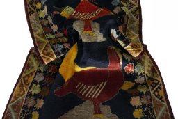 Corner detail of 2000s Persian Gabbeh rug showing border pattern and Wool pile