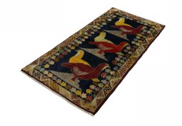 Corner detail of 2000s Persian Gabbeh rug showing border pattern and Wool pile