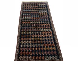 Surface texture of 2000s Persian Gabbeh rug with natural Wool and intricate pattern