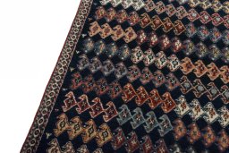 Backside of handmade 2000s Persian Gabbeh rug showing knot structure and weave density