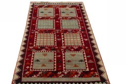 Surface texture of 2000s Persian Gabbeh rug with natural Wool and intricate pattern