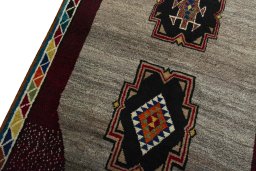 Backside of handmade 2000s Persian Gabbeh rug showing knot structure and weave density