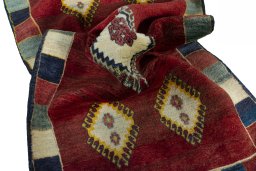 Corner detail of 2000s Persian Gabbeh rug showing border pattern and Wool pile