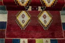 Full view of 2000s Persian Gabbeh rug from Iran / Persia, 193 × 104 cm in Red tones
