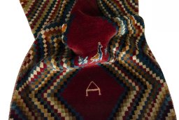Corner detail of 2000s Persian Gabbeh rug showing border pattern and Wool pile