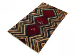 Corner detail of 2000s Persian Gabbeh rug showing border pattern and Wool pile