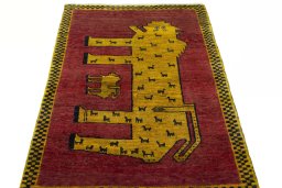 Surface texture of 2000s Persian Gabbeh rug with natural Wool and intricate pattern
