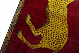 Backside of handmade 2000s Persian Gabbeh rug showing knot structure and weave density