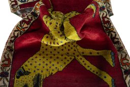 Corner detail of 2000s Persian Gabbeh rug showing border pattern and Wool pile