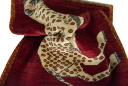 Corner detail of 2000s Persian Gabbeh rug showing border pattern and Wool pile