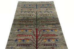 Surface texture of 2000s Persian Gabbeh rug with natural Wool and intricate pattern