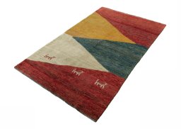 Corner detail of 2000s Persian Gabbeh rug showing border pattern and Wool pile