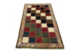 Surface texture of 2000s Persian Gabbeh rug with natural Wool and intricate pattern
