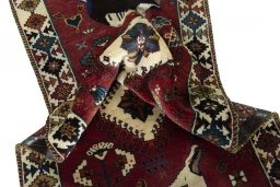 Corner detail of 2000s Persian Gabbeh rug showing border pattern and Wool pile