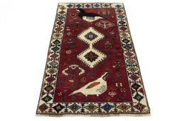 Surface texture of 2000s Persian Gabbeh rug with natural Wool and intricate pattern