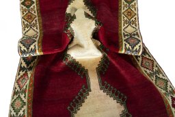 Corner detail of 2000s Persian Gabbeh rug showing border pattern and Wool pile