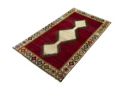 Corner detail of 2000s Persian Gabbeh rug showing border pattern and Wool pile