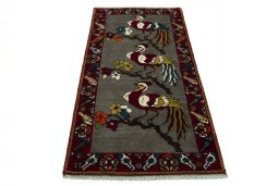 Surface texture of 2000s Persian Gabbeh rug with natural Wool and intricate pattern