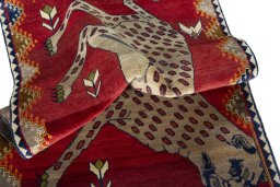 Corner detail of 2000s Persian Gabbeh rug showing border pattern and Wool pile