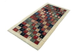 Corner detail of 2000s Persian Gabbeh rug showing border pattern and Wool pile
