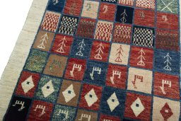 Backside of handmade 2000s Persian Gabbeh rug showing knot structure and weave density