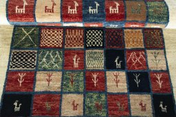 Full view of 2000s Persian Gabbeh rug from Iran / Persia, 234 × 116 cm in Multi Color tones