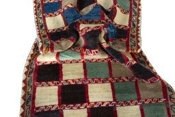 Corner detail of 2000s Persian Gabbeh rug showing border pattern and Wool pile