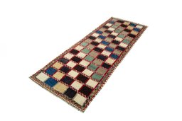 Corner detail of 2000s Persian Gabbeh rug showing border pattern and Wool pile
